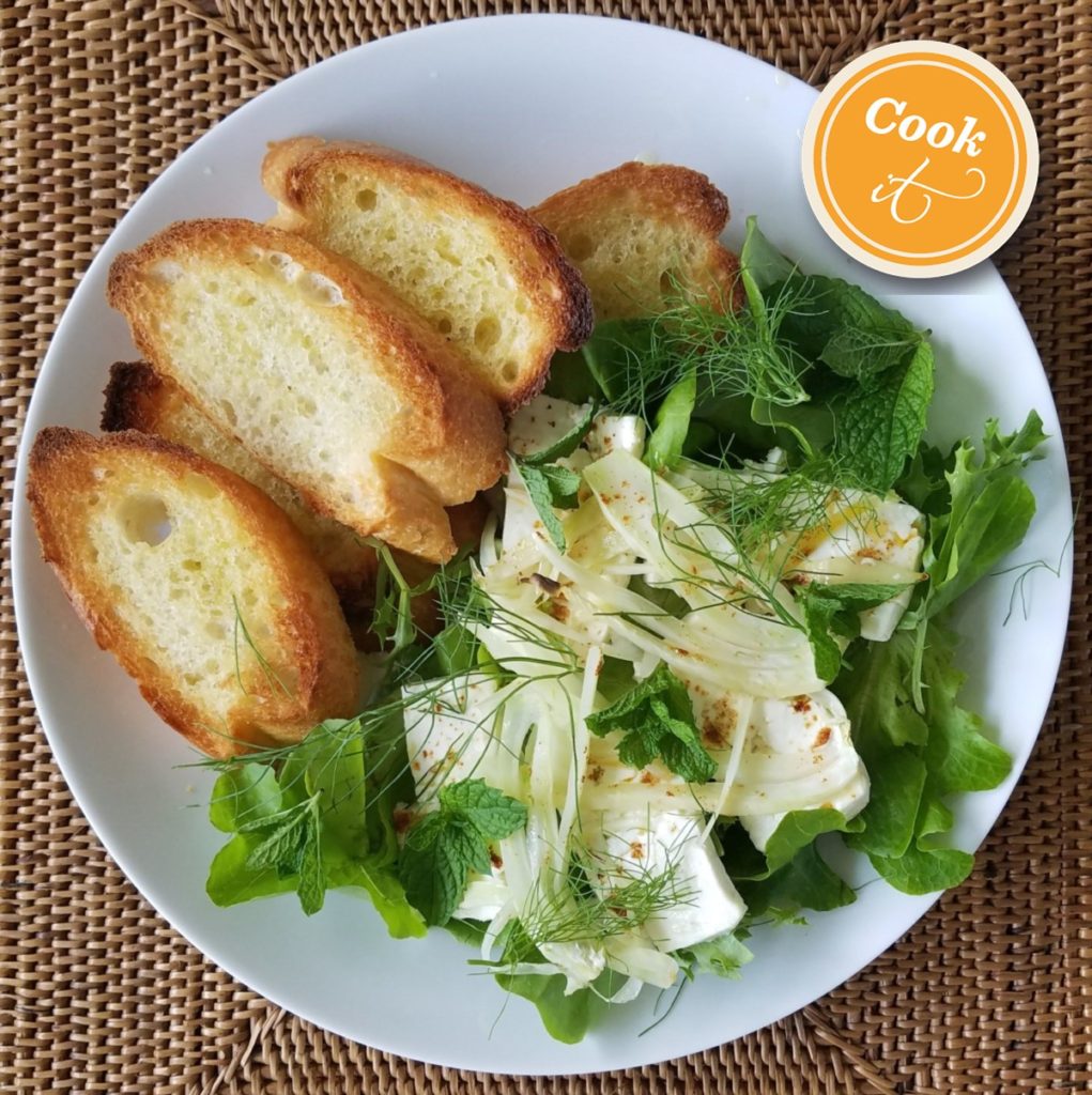 broiled feta with fennel on microgreens